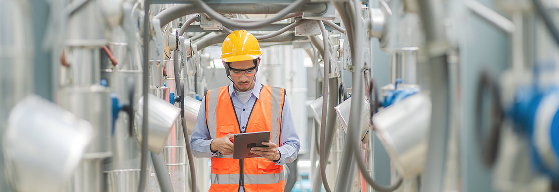 A worker reviewing information on a tablet